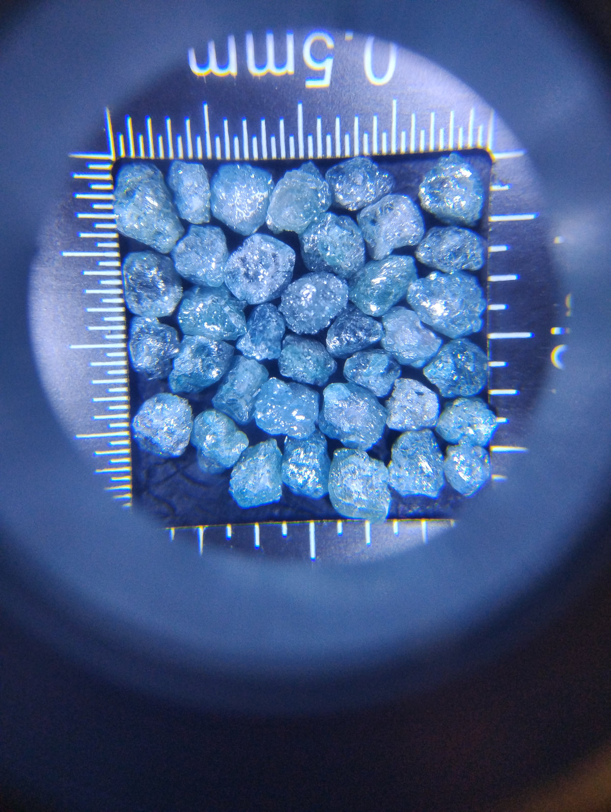 Nine carats of natural uncut blue diamonds in a rough gemstone lot, showcasing raw, unpolished blue gemstones from Rough Diamonds by Mr.