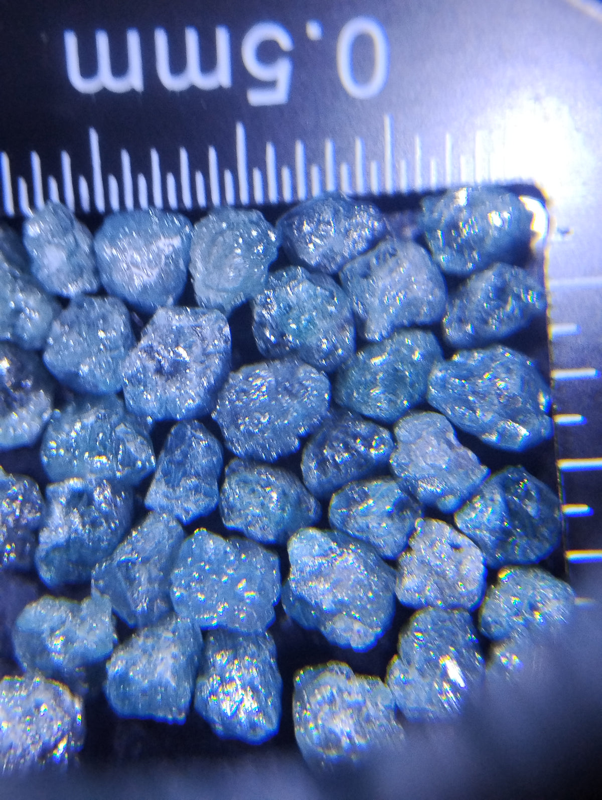 Loose natural uncut blue diamonds, 9 carats, raw rough gemstone lot by Rough Diamonds by Mr, showcasing unpolished blue gemstone clusters.